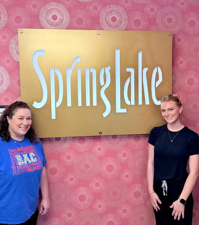 Skilled Nursing & Rehabilitation team at Spring Lake, LA, posing by facility sign