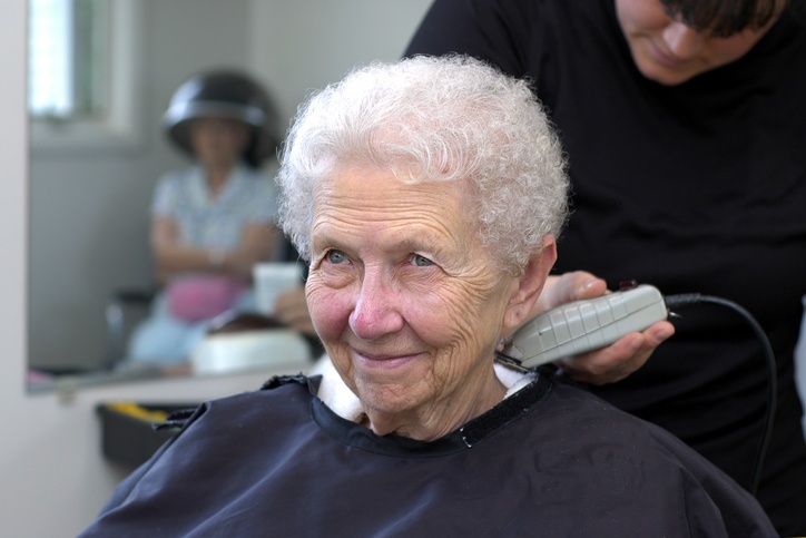 Senior Woman enjoys haircut at skilled nursing facility of Spring Lake Nursing & Rehabilitation Activities in Shreveport, LA