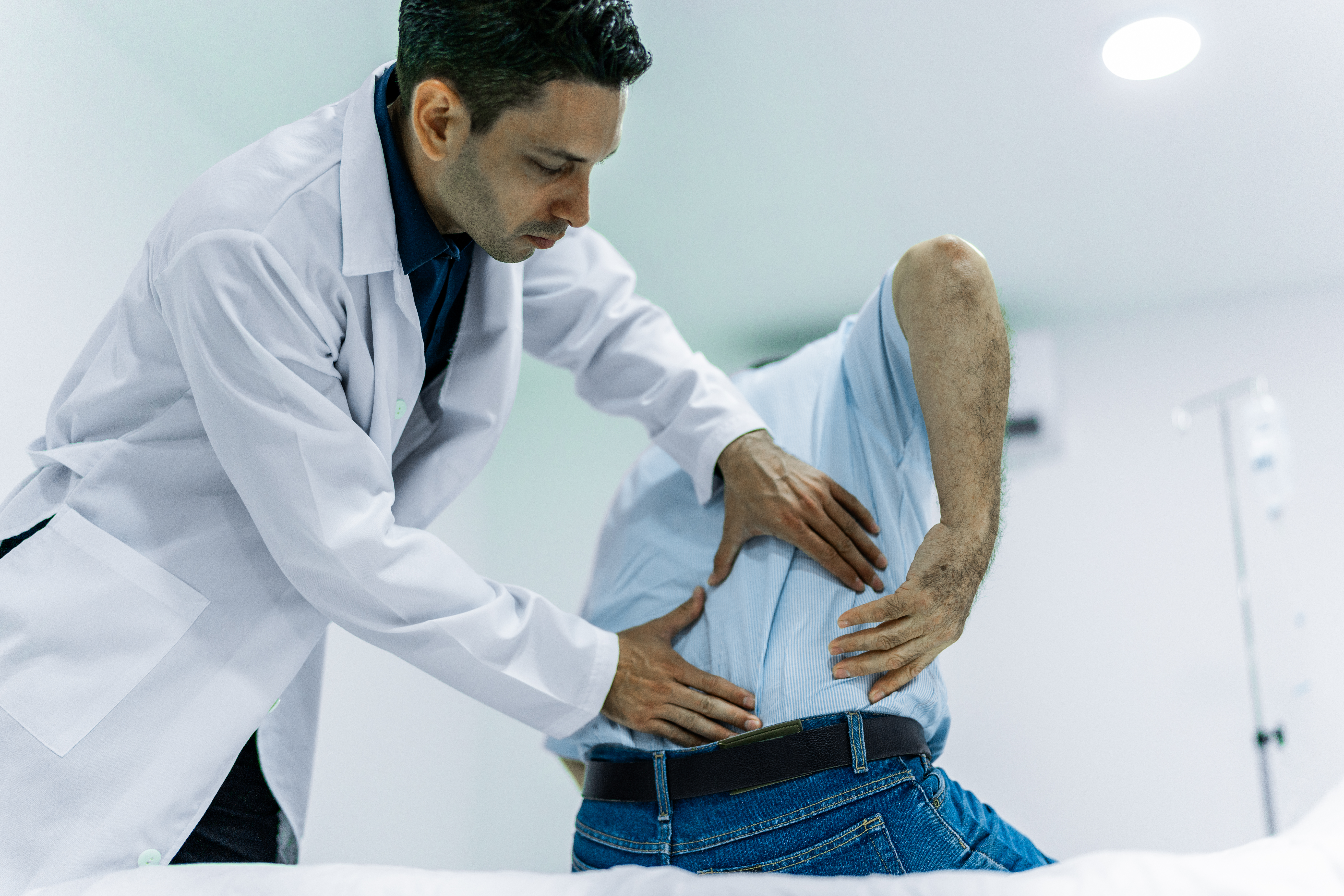 Doctor examining a elderly patient in pain at Spring Lake Skilled Nursing & Rehabilitation in Shreveport, LA.
